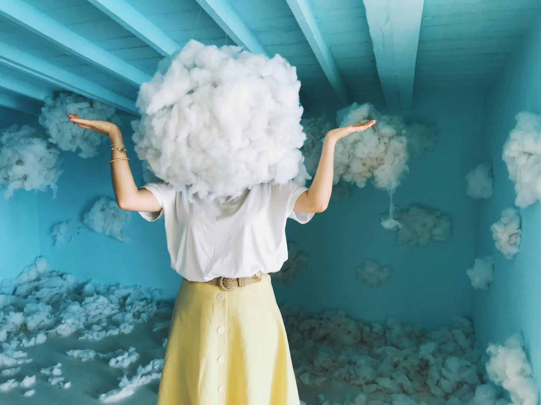 surreal cloud head art in blue room